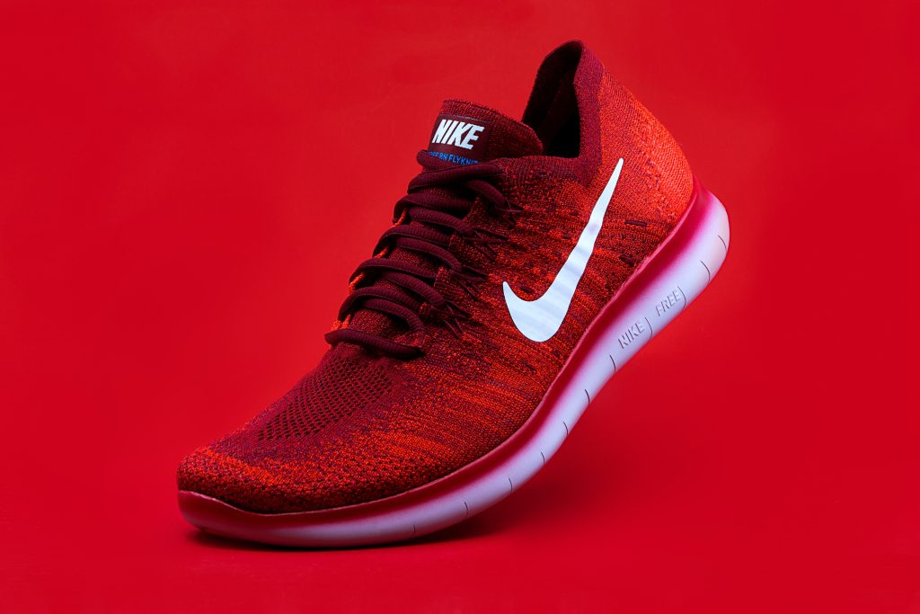 Red Nike shoe with white swoosh logo